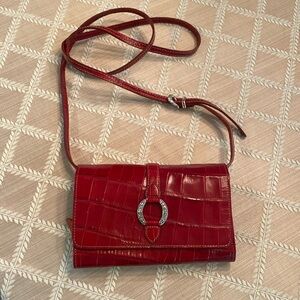 Brighton clutch/ wallet Strap can be removed.